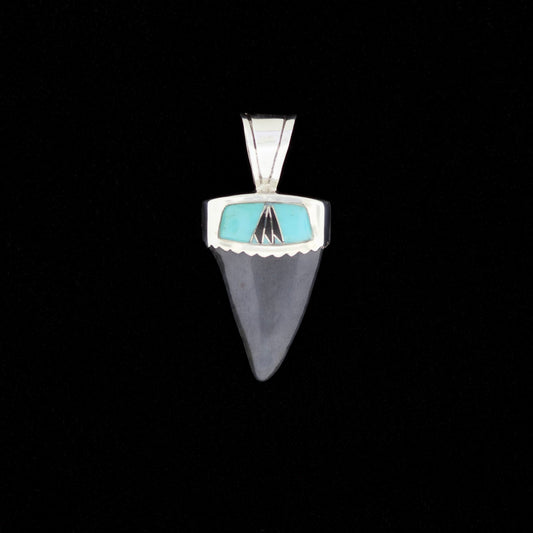 Fossil mako shark tooth pendant with blue turquoise and black onyx inlay on a black background