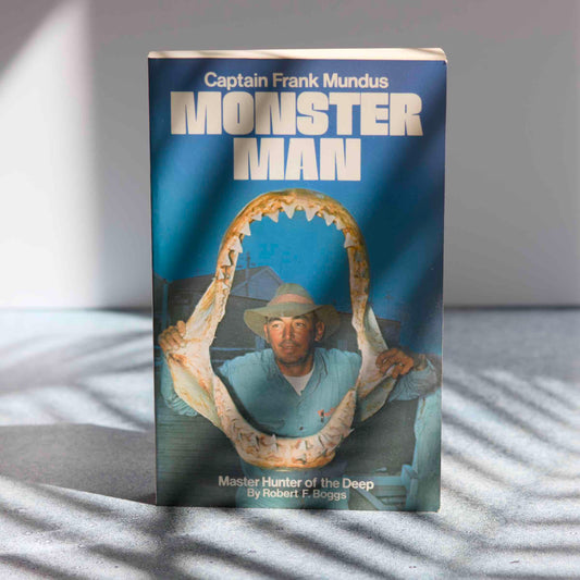 Book titled 'Monster Man' with a cover featuring a man in a hat and shark jaws.